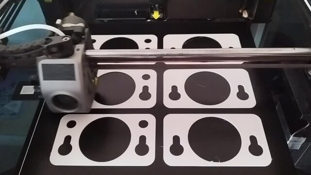 3D printer machining several parts in series. Concept of technology, industry, innovation, future, engineering, design, developement, production, manufacturing, accuracy, precision, safety, machining