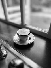 Coffee: black and white image of a cup of freshly brewed espresso