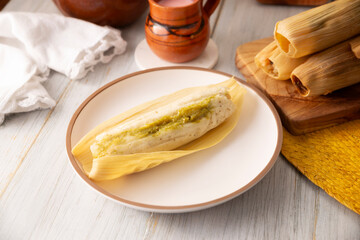 Tamales. hispanic dish typical of Mexico and some Latin American countries. Corn dough wrapped in corn leaves. The tamales are steamed.