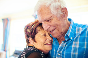 Love, senior couple and hug in home for support, dance and commitment in relationship. Elderly people, happy and embrace in living room for retirement security, good news and milestone celebration