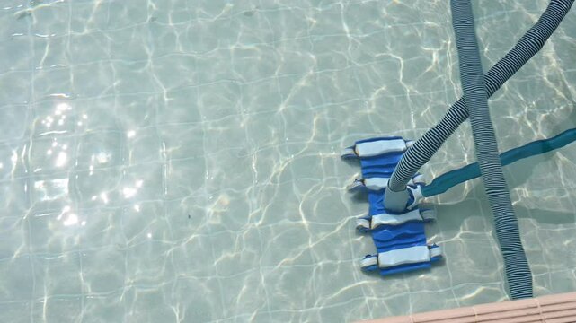 Pool cleaning. Cleaning summer pool using vacuum cleaner