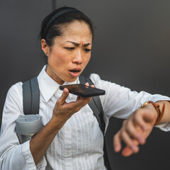 furious japanese mature woman check time while record voice mail
