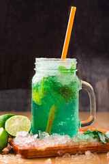 MOCKTAIL MOJITO with Refreshing Mint Lemonade with Lime and Ice served in jar with straw isolated on wooden board side view of perfect drink for a hot summer day © Food Shop