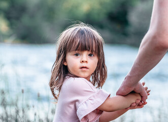 Portrait of a little girl holding her parent