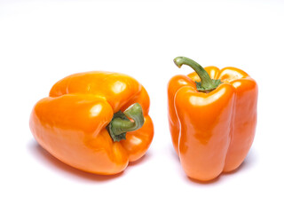 Orange bell peppers against white background.