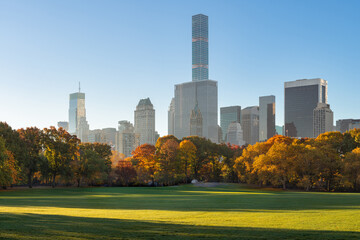 New York City early morning view of Central Park Sheep Meadow in autumn with view of Midtown Manhattan skyscrapers