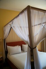 Guest bed with mosquito net in an African house