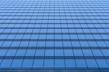 A fragment of a high-rise building with glass walls. Beautiful geometric background