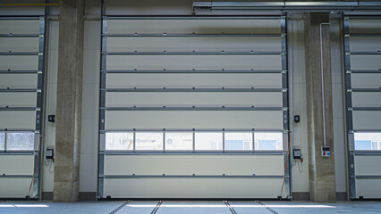 Entrance gates to a modern warehouse. Docks for trucks.  Tin white doors 