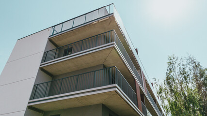 Modern residential or office building. under construction Wide angle shot from a drone. Large balconies with metal railings and glass.