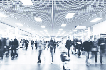 Crowd of people in the airport. No recognizable faces