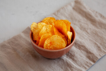 Homemade Flavored Cheese Potato Chips in a Bowl, side view.