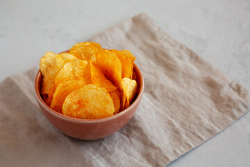 Homemade Flavored Cheese Potato Chips in a Bowl, side view.