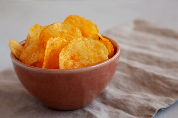 Homemade Flavored Cheese Potato Chips in a Bowl, low angle view.
