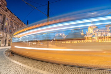 Budapest, Hungary: July 08, 2024: Tram motion blur line. Lajos Square at twilight. Parliament on the background. Long exposure shot.