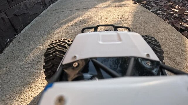 POV Rc car navigating path and grass in outdoor adventure