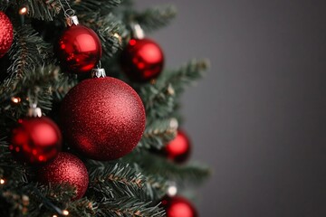 Obraz premium Red Christmas balls decorate a Christmas tree. Selective focus.