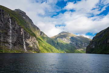 Fototapeta premium view of the beautiful waterfall seven sisters geiranger fjord in norway with mountains rocks and