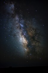 Dark night sky with Milky Way shining bright. Glowing galaxy illuminates the vast space. Stars twinkle in the universe. Aesthetic view of cosmic night scene.