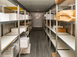 Refrigeration chamber for food storage. Shelves in the warehouse with boxes.