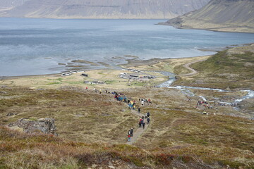 Isafjordur, Iceland - tourists hiking and walking around at Dynjandi, Fjallfoss cascading waterfall...