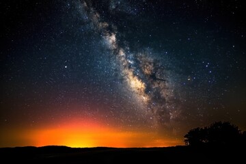 Starry night sky with milky way over mountain landscape during golden hour sunset. Silhouette of rugged terrain, dark clouds against vibrant celestial display. Colorful stars, galaxies in Arizona