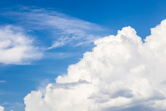 large cumuli cloud and cirrus clouds in blue sky