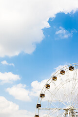 observation wheel and white clouds in blue sky