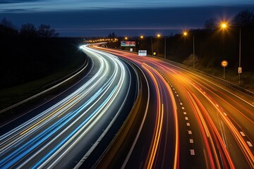 Fast moving traffic on M42 motorway at night creates trails on road. Red glow from headlights, dark background, speeding cars, vans, trucks. Highway, expressway, road, traffic, speed, fast, night,