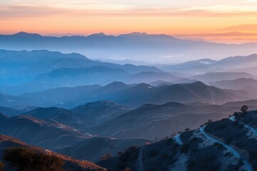Fototapeta premium Mountain range at sunset from top angle. Clouds gather above peaks. Scenic landscape with rock formation in background. Natural surroundings, serene atmosphere, summer vibes, outdoor adventure.