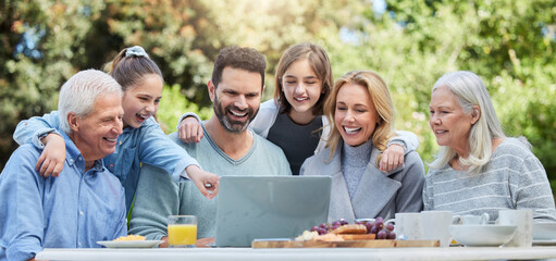 Family, generations and outdoor with smile on laptop for streaming service and funny videos in Australia. People, grandparents and parents with kids in park on internet for memes on social media post