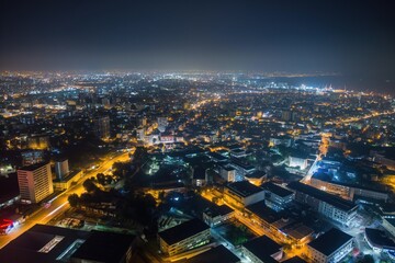 Accra cityscape at night with illuminated skyscrapers, modern architecture, and bustling streets. Railway and road networks connect the urban area. People and vehicles move through the city.