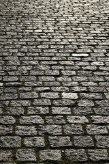 Cobblestone pavement background. Textured background of cobblestone road. Cobblestone pavement for background. Cobblestone road background.