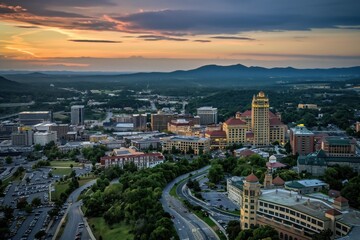 Obraz premium Aerial shot of Roanoke city with beautiful architecture. Cityscape in Virginia features historic buildings, modern skyscrapers, rich green plants. Urban landscape with scenic views of downtown area.
