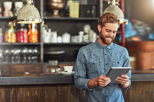 Business, man and smile with tablet in cafe of social media update, menu planning and order management. Startup, male person and digital for website review, inventory and stock schedule of restaurant