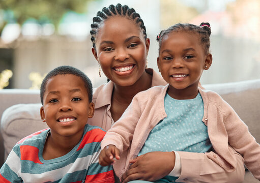 Portrait, happy black family and mother with kids on sofa at home for love, care or people relax. Smile, face or African children with mom for hug, trust or support with single parent or babysitter