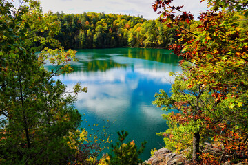 Pink Lake, a meromictic lake at Gatineau Park as seen from a rocky outcrop amidst magnificent...