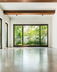 Fototapeta premium Modern empty living room with large glass doors and scenic view of garden, featuring concrete floor and wooden ceiling beams.