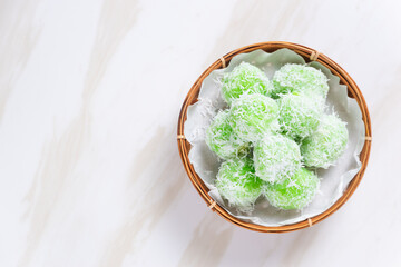 klepon or onde-onde made from glutinous rice flour and filled with brown sugar covered with grated coconut. Perfect for recipe, article, catalogue, commercial, or any cooking content.