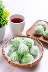 klepon or onde-onde made from glutinous rice flour and filled with brown sugar covered with grated coconut. Perfect for recipe, article, catalogue, commercial, or any cooking content.