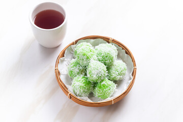 klepon or onde-onde made from glutinous rice flour and filled with brown sugar covered with grated coconut. Perfect for recipe, article, catalogue, commercial, or any cooking content.