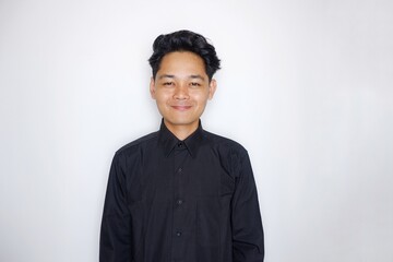 Portrait of a handsome Indonesian man wearing a plain black shirt with a random pose isolated on a white background