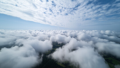 Obraz premium Aerial high flight above the clouds. The rays of the rising sun break through the clouds.