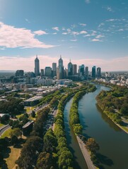 Obraz premium Melbourne cityscape with river and green trees on sunny day. Drone vertical shot captures skyscrapers and bridge. Green plants and water blend in urban landscape.