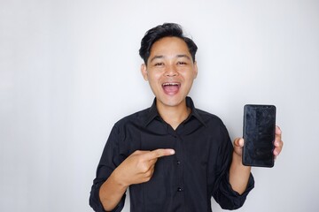 Portrait of a handsome Indonesian man wearing a plain black shirt with a random pose isolated on a...