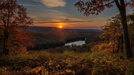Fototapeta premium Aerial view of a serene autumnal landscape in Pocono Mountains. River flows gently past old stone buildings with a backdrop of vibrant fall foliage. Scenic view of lake and surrounding trees