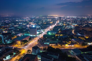 Obraz premium Aerial shot of Accra city at night. Modern Ghanaian architecture, cityscape, and infrastructure. Busy streets, roads, and railway lines. People and vehicles moving, city life.