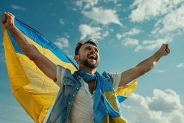 A man proudly holds a vibrant Ukraine flag in a clear blue sky, dressed casually in a white t-shirt and blue and yellow scarf. The flag flutters slightly in the breeze, adding movement to the scene.