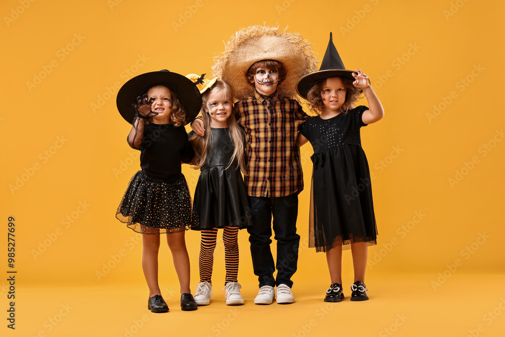 Canvas Prints Cute children wearing Halloween costumes on orange background