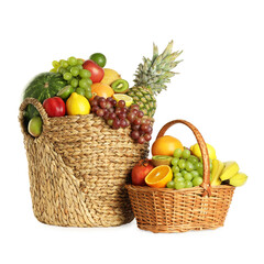 Many fresh ripe fruits in baskets isolated on white